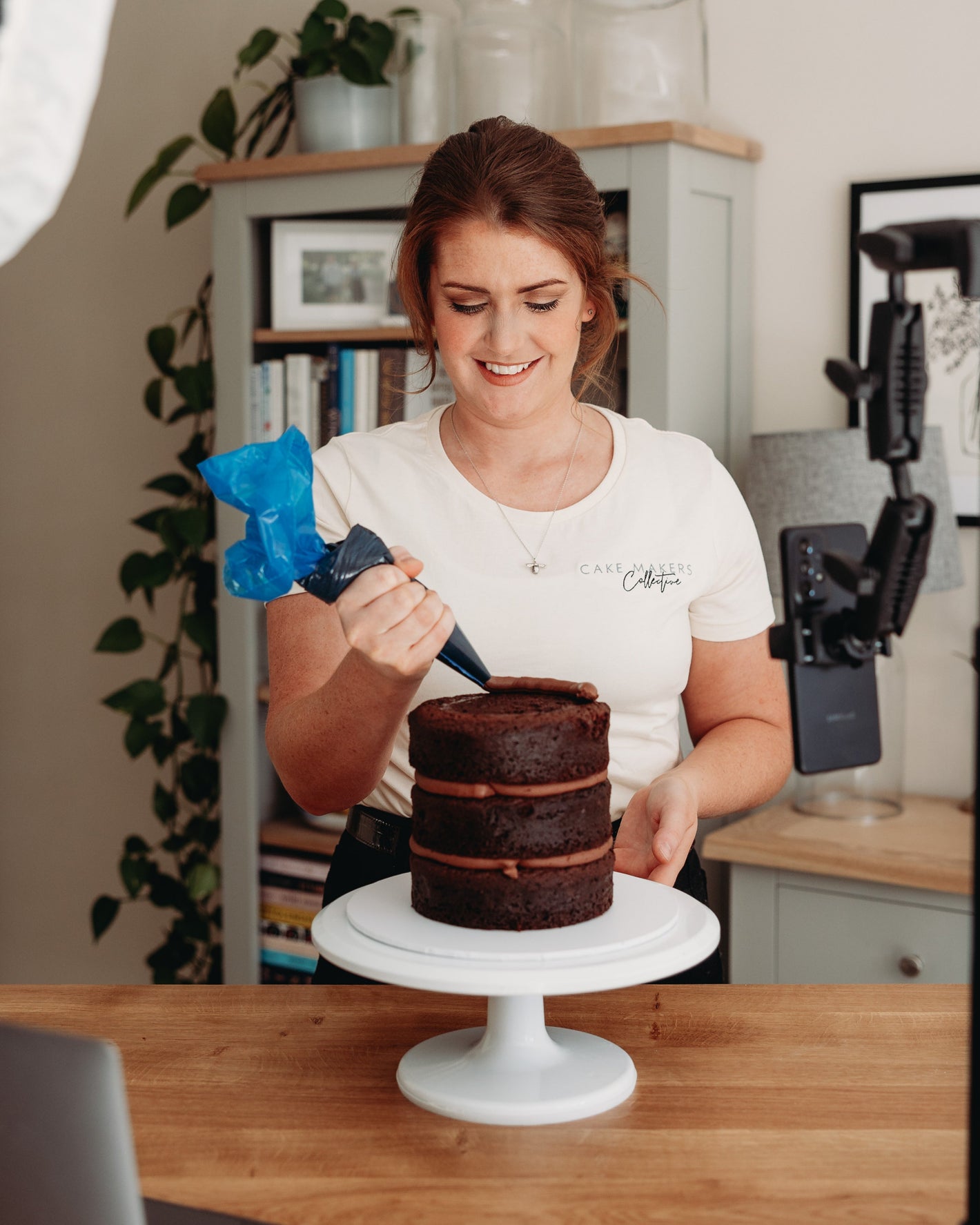 Woman decorating a cake for an online cake class